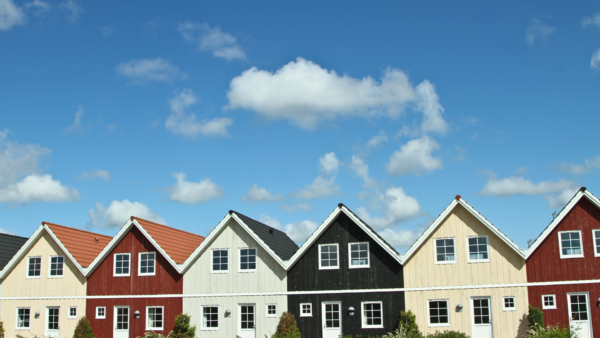 row of houses under a sunny but cloudy blue sky - talking about real estate accountants