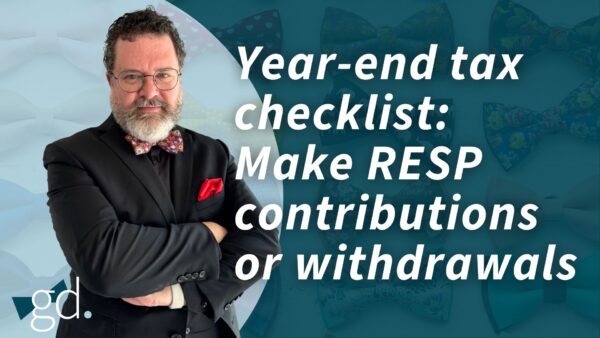 Man in a black suit with beard, glasses, and reddish bowtie