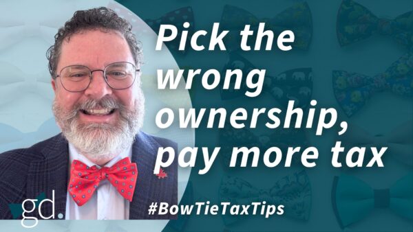White male with dark, short hair, glasses, and whitish beard with red bow tie, dark jacket and light shirt talking about Partnership vs joint ownership of real estate