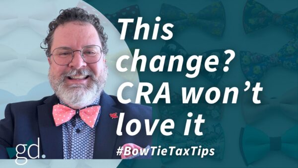 Man with glasses and curly dark hair that is short with a whitish beard, wearing a pink polka dot and blue tie with blue shirt and dark jacket talking about adjusting your tax return in Canada