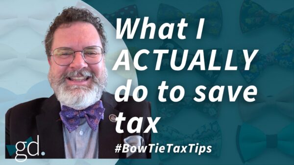 White male, dark curly hair, whitish beard, wearing glasses, a dark suit jacket, light shirt and purple bow tie talking about "how i save taxes"