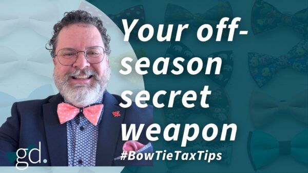 White male, dark curly hair, whitish beard, wearing glasses, a dark suit jacket, light shirt and purple bow tie talking about "tax checklists for business owners"