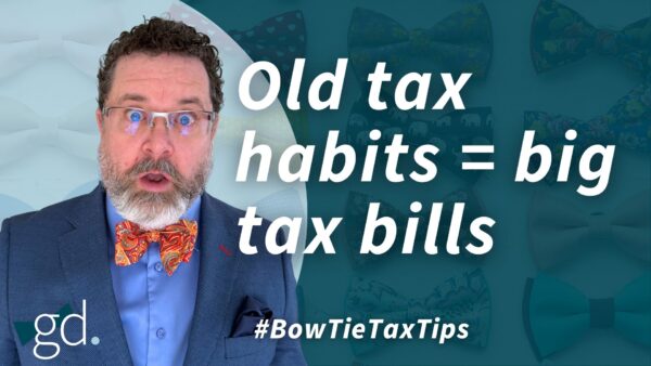 White male, dark curly hair, whitish beard, wearing glasses, a dark suit jacket, blue shirt and orange patterned bow tie talking about rethinking tax strategies for real estate investors