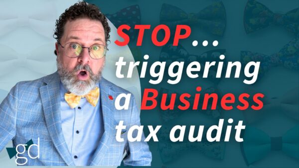 White male, dark curly hair, whitish beard, wearing glasses, a light blue suit jacket, blue shirt and yellow patterned bow tie talking about avoiding an audit on your business taxes